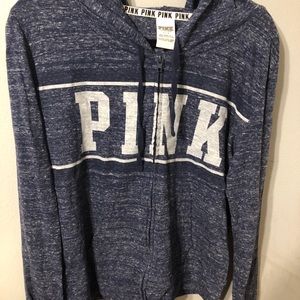 Pink full zip sweater.